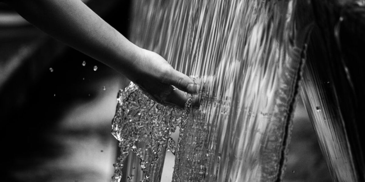 Photo by Tony Mucci: https://www.pexels.com/photo/grayscale-photo-of-persons-hand-on-water-5367191/