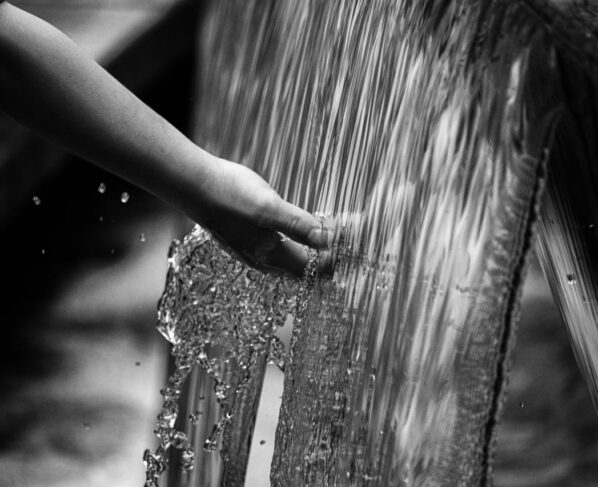 Photo by Tony Mucci: https://www.pexels.com/photo/grayscale-photo-of-persons-hand-on-water-5367191/