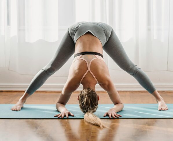 Photo by Marta Wave: https://www.pexels.com/photo/slim-woman-doing-yoga-in-wide-legged-forward-bend-pose-6454068/