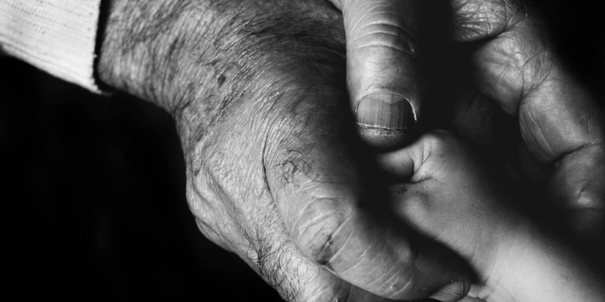Photo by Danny Doneo: https://www.pexels.com/photo/grayscale-photo-of-an-elderly-person-holding-a-baby-s-hand-10421160/