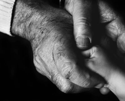 Photo by Danny Doneo: https://www.pexels.com/photo/grayscale-photo-of-an-elderly-person-holding-a-baby-s-hand-10421160/