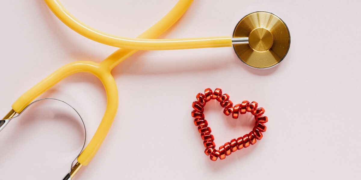 Photo by Photo By: Kaboompics.com: https://www.pexels.com/photo/stethoscope-near-decorative-coil-tie-in-heart-shape-on-pink-surface-4226769/