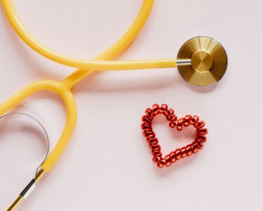 Photo by Photo By: Kaboompics.com: https://www.pexels.com/photo/stethoscope-near-decorative-coil-tie-in-heart-shape-on-pink-surface-4226769/