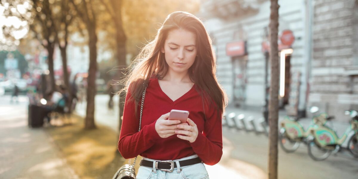 Photo by Andrea Piacquadio: https://www.pexels.com/photo/woman-in-red-long-sleeve-shirt-and-blue-denim-jeans-looking-at-her-cellphone-3764006/