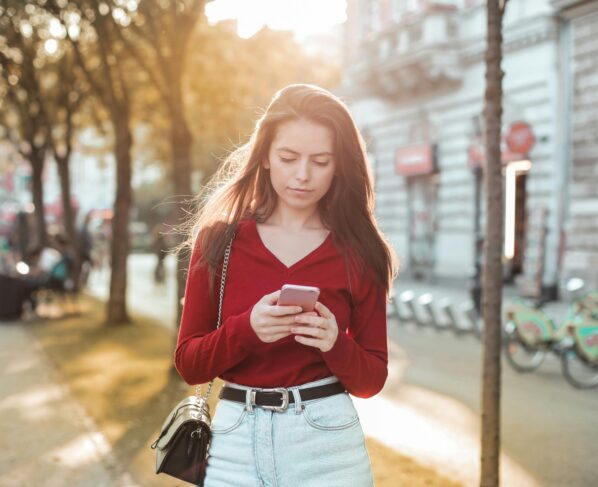 Photo by Andrea Piacquadio: https://www.pexels.com/photo/woman-in-red-long-sleeve-shirt-and-blue-denim-jeans-looking-at-her-cellphone-3764006/