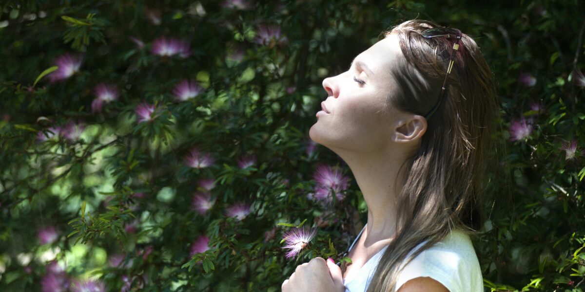 Photo by Alex P: https://www.pexels.com/photo/woman-closing-her-eyes-against-sun-light-standing-near-purple-petaled-flower-plant-321576/