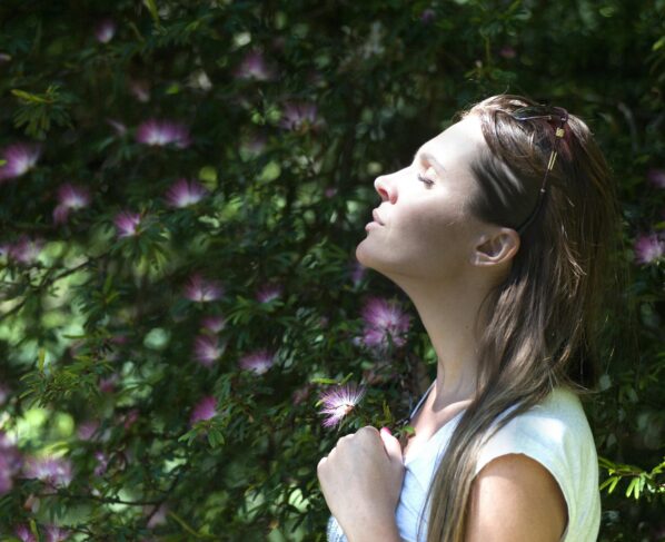 Photo by Alex P: https://www.pexels.com/photo/woman-closing-her-eyes-against-sun-light-standing-near-purple-petaled-flower-plant-321576/