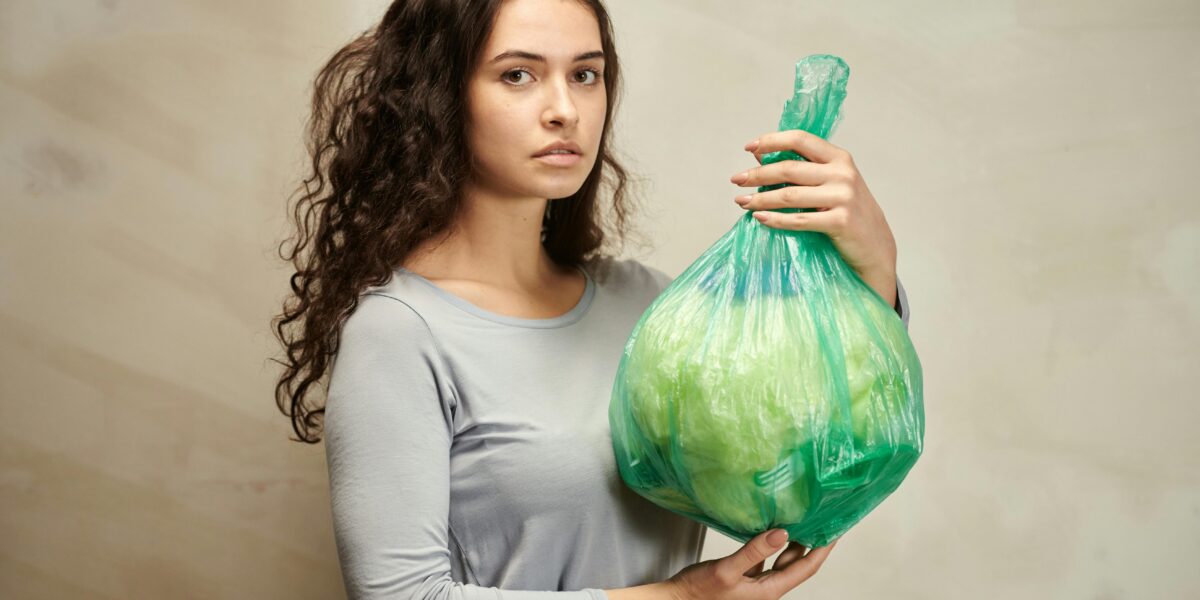 Photo by Julia M Cameron: https://www.pexels.com/photo/a-woman-holding-green-plastic-bag-6995450/