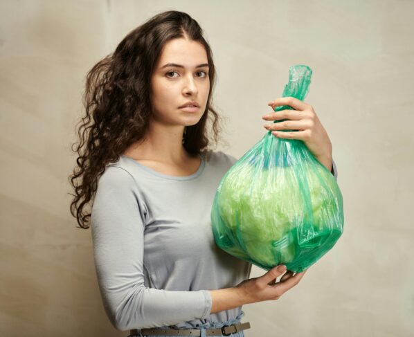 Photo by Julia M Cameron: https://www.pexels.com/photo/a-woman-holding-green-plastic-bag-6995450/