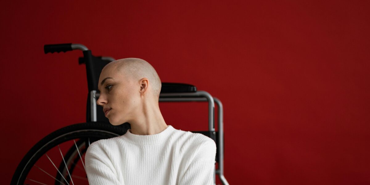 Photo by SHVETS production: https://www.pexels.com/photo/melancholic-woman-leaning-on-wheelchair-and-looking-away-pensively-6984627/