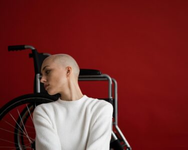 Photo by SHVETS production: https://www.pexels.com/photo/melancholic-woman-leaning-on-wheelchair-and-looking-away-pensively-6984627/