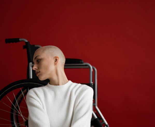 Photo by SHVETS production: https://www.pexels.com/photo/melancholic-woman-leaning-on-wheelchair-and-looking-away-pensively-6984627/