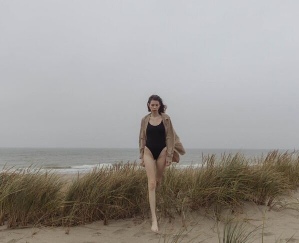 Photo by Yaroslav Shuraev: https://www.pexels.com/photo/woman-in-black-swimsuit-standing-on-green-grass-field-near-body-of-water-5980141/