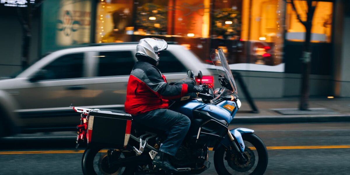 Photo by Josh Hild: https://www.pexels.com/photo/motorcyclist-riding-through-seattle-street-30167817/