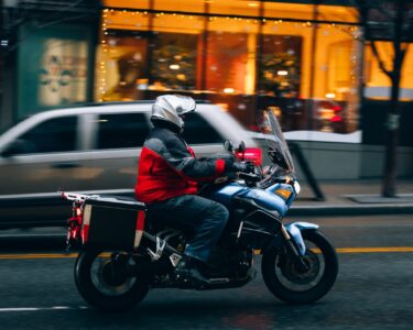 Photo by Josh Hild: https://www.pexels.com/photo/motorcyclist-riding-through-seattle-street-30167817/