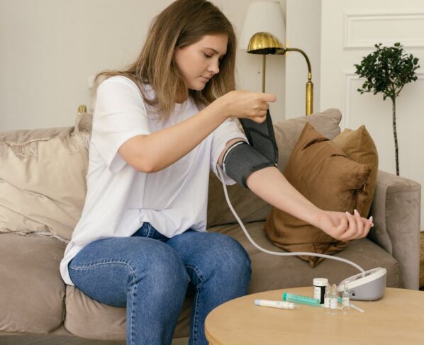 Photo by Mikhail Nilov: https://www.pexels.com/photo/a-woman-in-white-shirt-checking-her-blood-pressure-8670518/