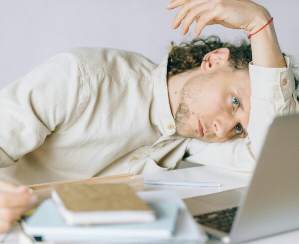 Photo by Nataliya Vaitkevich: https://www.pexels.com/photo/overworked-employee-lying-in-front-of-laptop-6837648/