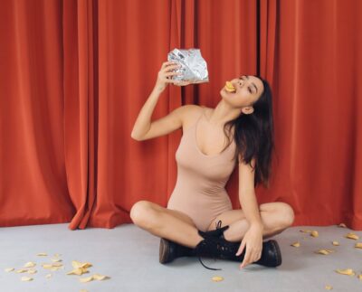 Photo by Polina Tankilevitch: https://www.pexels.com/photo/a-young-woman-posing-while-eating-potato-chips-6516020/