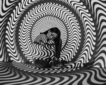 Photo by cottonbro studio: https://www.pexels.com/photo/woman-sitting-near-black-and-white-striped-wall-6492156/