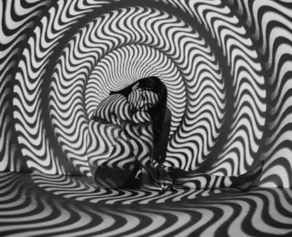 Photo by cottonbro studio: https://www.pexels.com/photo/woman-sitting-near-black-and-white-striped-wall-6492156/