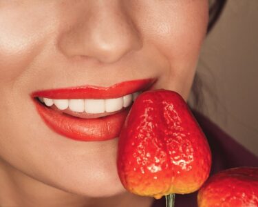 Photo by Inna Mykytas: https://www.pexels.com/photo/woman-with-red-lipstick-holding-a-strawberry-7866503/
