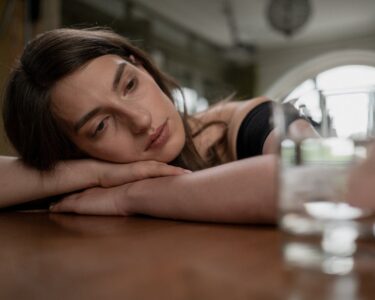 Photo by cottonbro studio: https://www.pexels.com/photo/sad-woman-on-a-wooden-table-10496234/