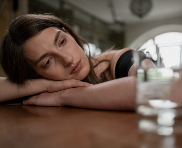 Photo by cottonbro studio: https://www.pexels.com/photo/sad-woman-on-a-wooden-table-10496234/