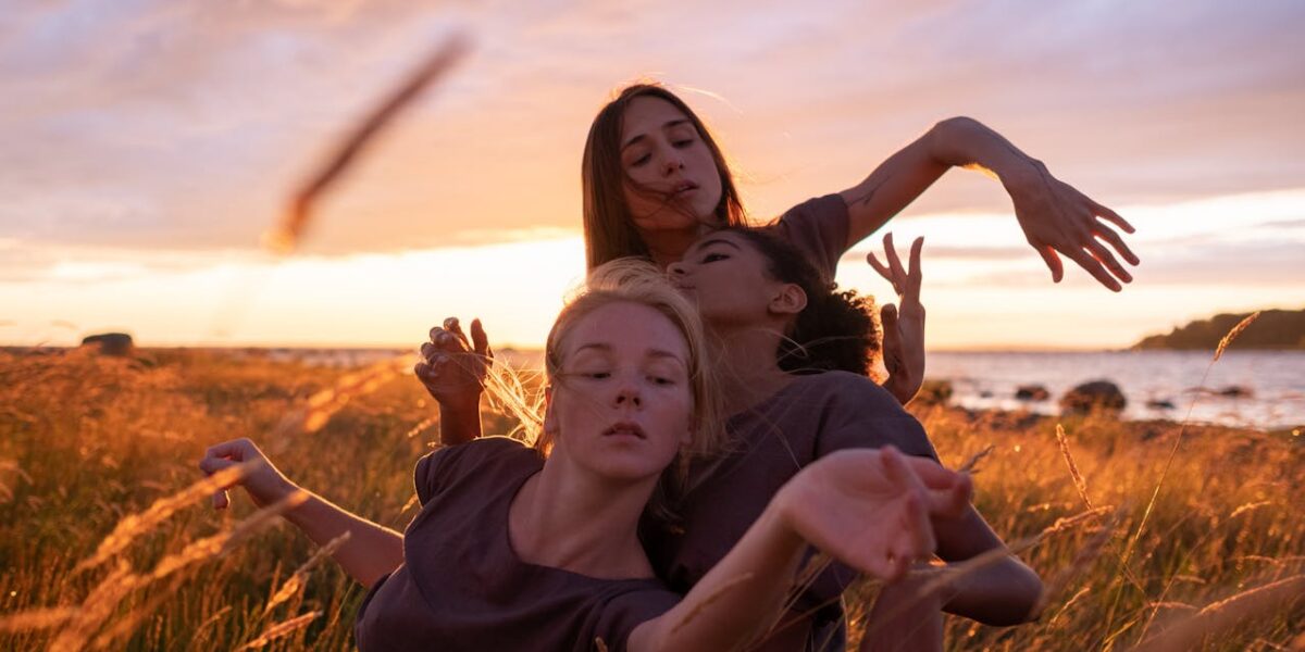 Photo by cottonbro studio: https://www.pexels.com/photo/three-women-dancing-on-grass-field-during-sunrise-10570884/