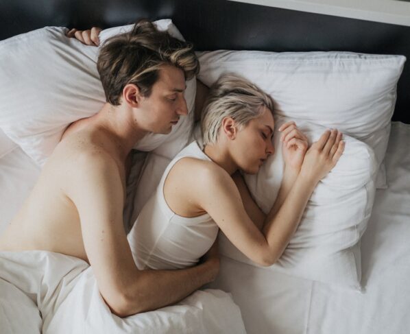 Photo by cottonbro studio: https://www.pexels.com/photo/young-couple-sleeping-together-in-bed-9374135/