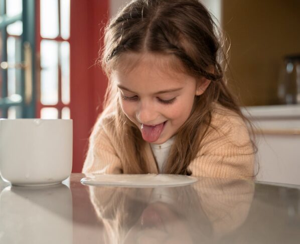 Photo by Ron Lach : https://www.pexels.com/photo/little-girl-sticking-out-tongue-leaning-towards-yogurt-spilled-on-table-8669768/