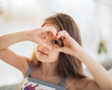 Photo by Elina Fairytale: https://www.pexels.com/photo/photo-of-a-girl-looking-through-a-heart-shape-6202032/