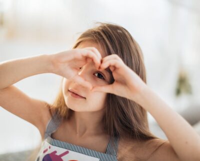 Photo by Elina Fairytale: https://www.pexels.com/photo/photo-of-a-girl-looking-through-a-heart-shape-6202032/