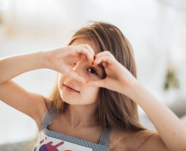 Photo by Elina Fairytale: https://www.pexels.com/photo/photo-of-a-girl-looking-through-a-heart-shape-6202032/