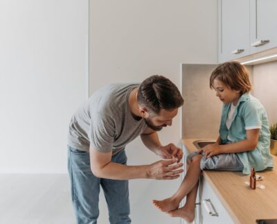 Photo by Pavel Danilyuk: https://www.pexels.com/photo/a-man-in-gray-shirt-looking-at-his-son-s-wounded-knee-8763103/