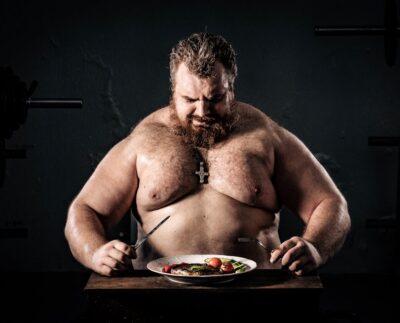 Photo by Alexa Popovich: https://www.pexels.com/photo/topless-man-holding-knife-and-fork-11254665/