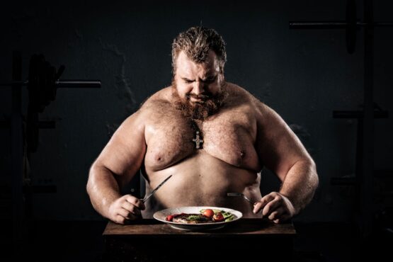 Photo by Alexa Popovich: https://www.pexels.com/photo/topless-man-holding-knife-and-fork-11254665/